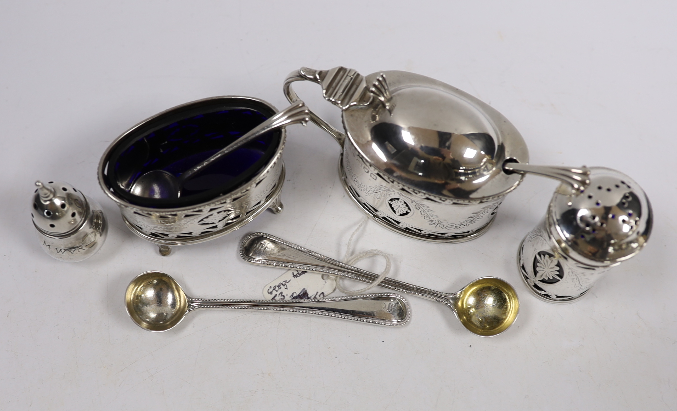 A George V pierced silver oval three piece cruet set and one spoon, Goldsmiths & Silversmiths Co Ltd, London, 1912, two Victorian silver condiment spoons and a sterling pepperette.